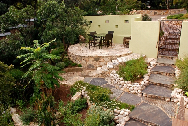 patio-terrasse-pierre-naturelle-clôture-plantes-vertes