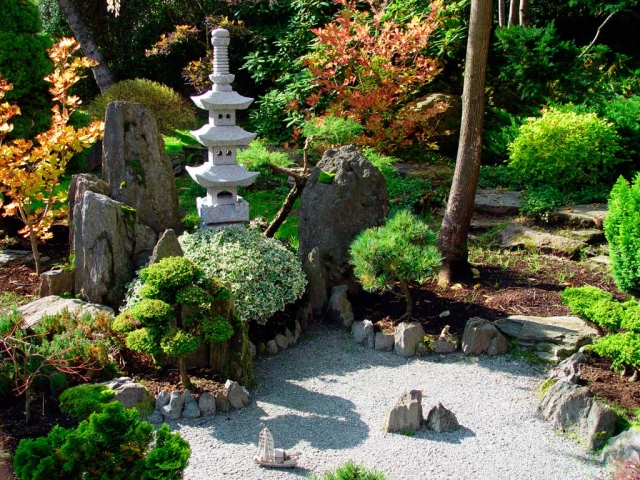 atmosphère-naturelle-jardin-zen-sable-blanc-statuette-pierres-naturelles-plantes-vertes-bonsais