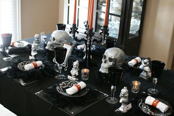 décoration-Halloween-table-idées-uniques-designers-crânes-argentés-dessous-assiettes-plumes-noires