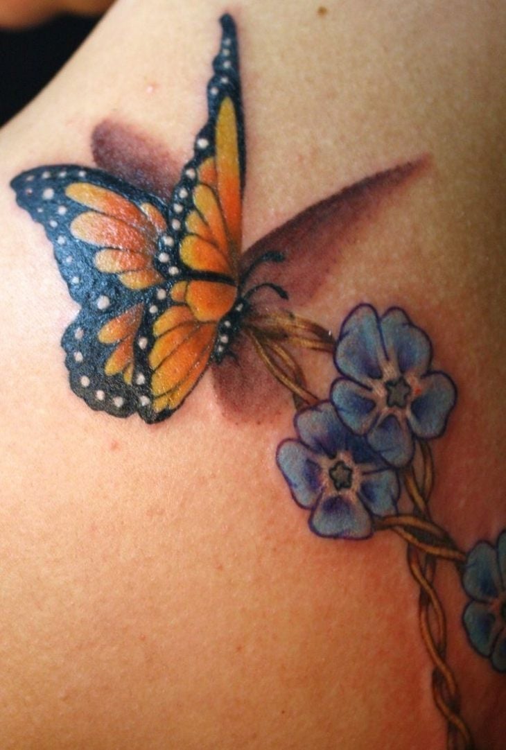 tatouage-papillon-multicolore-fleurs