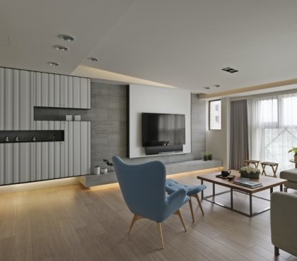 interieur-minimaliste-asiatique-mur-pierre-grise-niches-rangement-fauteuil-bleu
