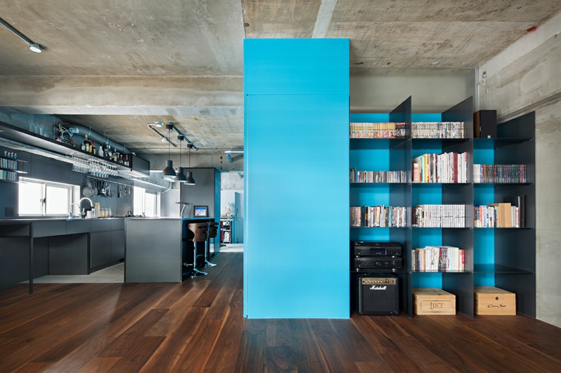 tendances-design-interieur-plafond-béton-brut-sol-bois-meuble-rangement-porte-bleue