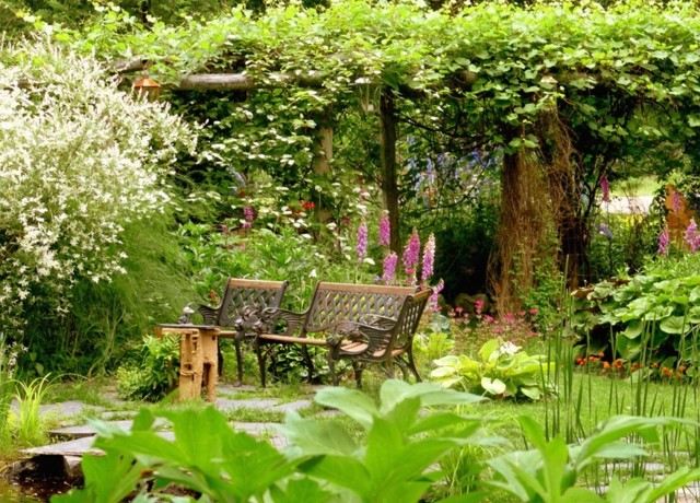 amenagement-jardin-pegola-recouverte-plantes-grimpantes-bancs-bois-plantes-vertes