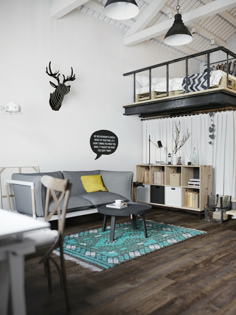 amenagement-studio-style-scandinave-tapis-turquoise-table-basse-noire-canapé-gris-commode-bois aménagement studio