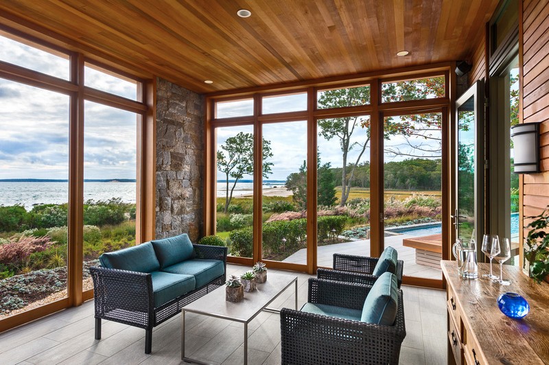 amenagement-veranda-moderne-vitree-bois-pierre-parement-salon-jardin-rotin véranda moderne