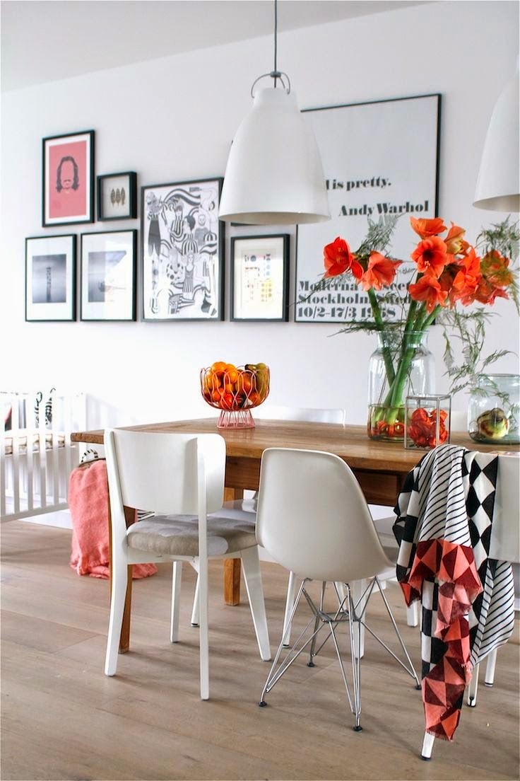 idee-deco-salle-manger-tableaux-collages-cadres-noirs-chaises-blanches-fleurs-orange idée déco salle à manger