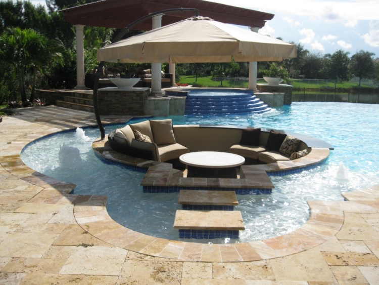 grande-piscine-extérieure-terrasse-pierre-canapé-intégré