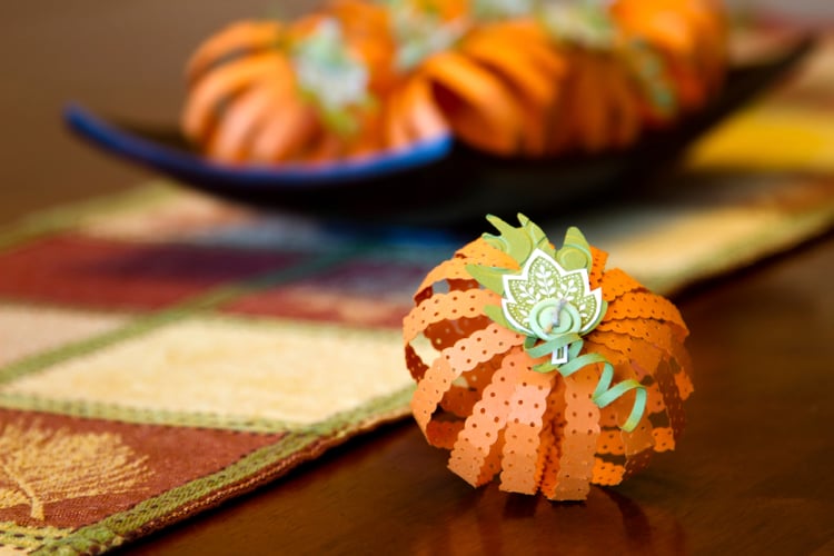 Fall pumpkin centerpiece crafted out of folded and stamped paper.