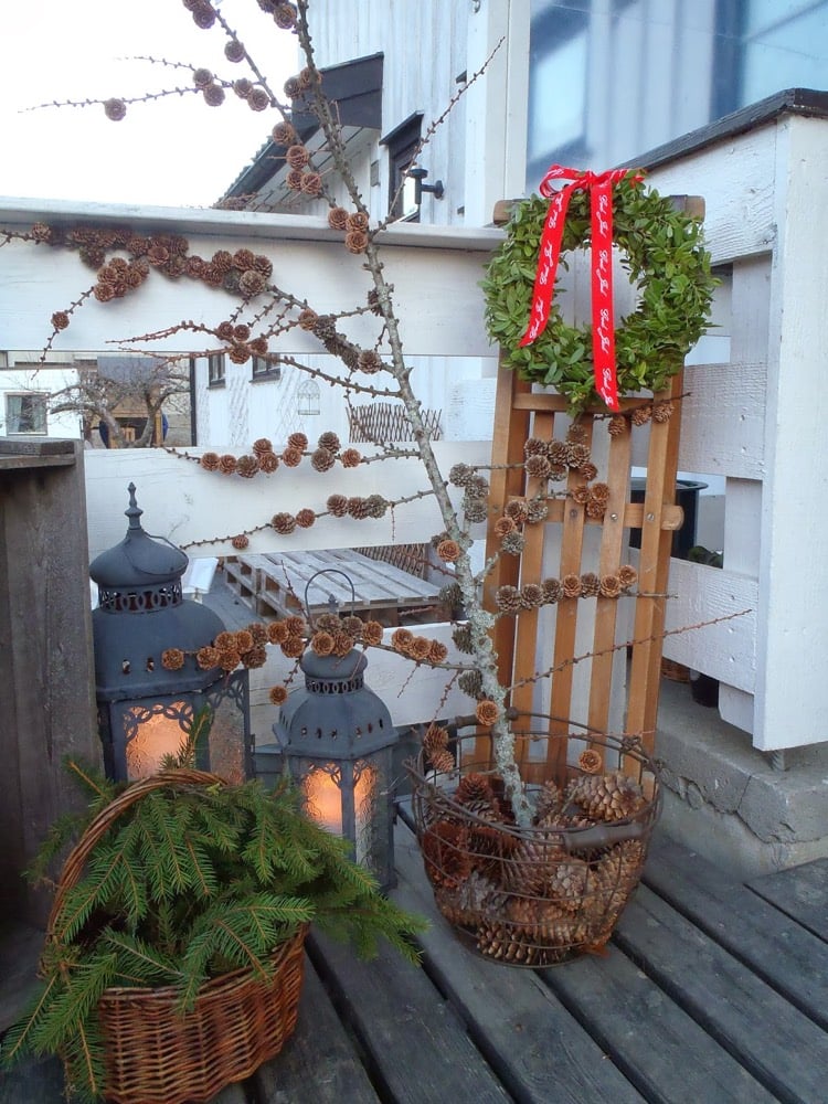 decoration-de-noel-exterieure-naturelle-pommes-pin-couronne-verdure-lanternes