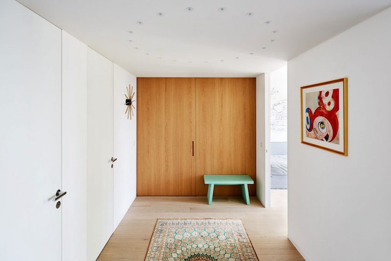 armoire-encastree portes en bois naturel-petit-banc-vert-eau-tapis-ethno