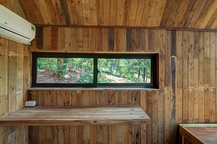 façade vitrée moderne petite cabane nature vietnamienne intérieur bardage bois
