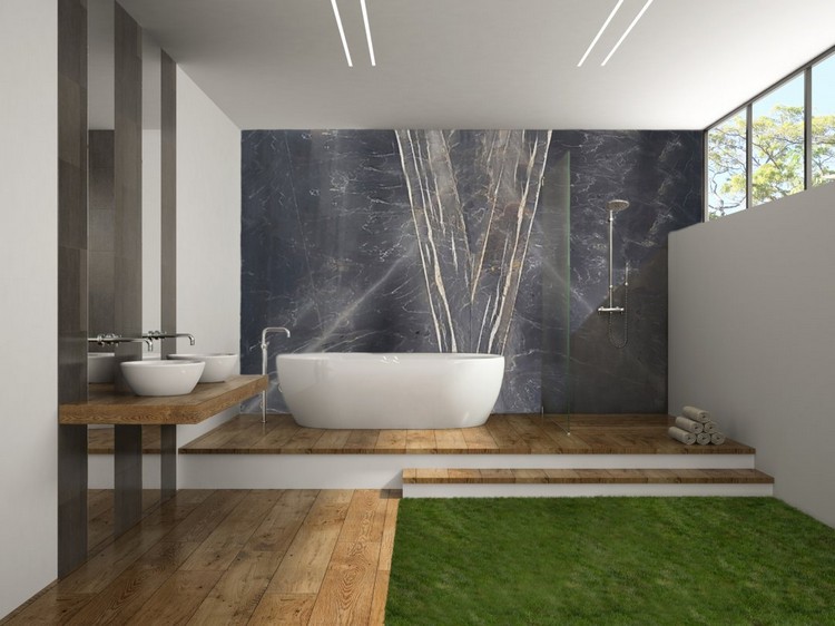 salle de bain avec douche italienne mur béton design baignoire blanche revêtement sol bois pelouse artificielle style zen