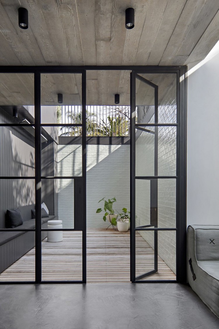 volets pliants design alu fenêtres sur mesure façade béton intérieur minimaliste