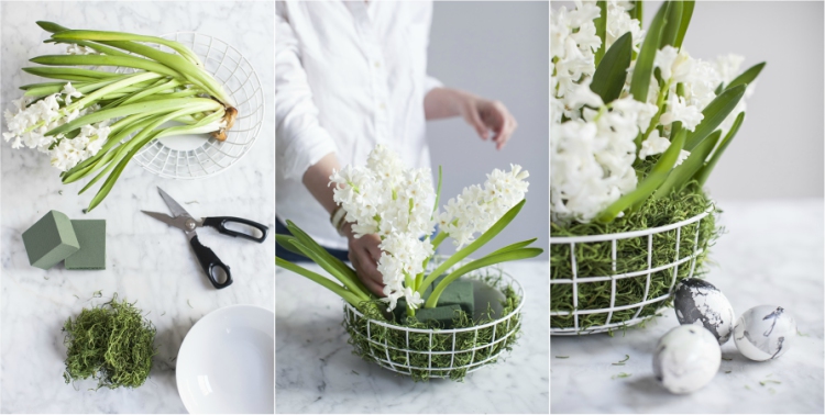 centre de table Paques en fleurs blanches et verdure dans un panier grillagé