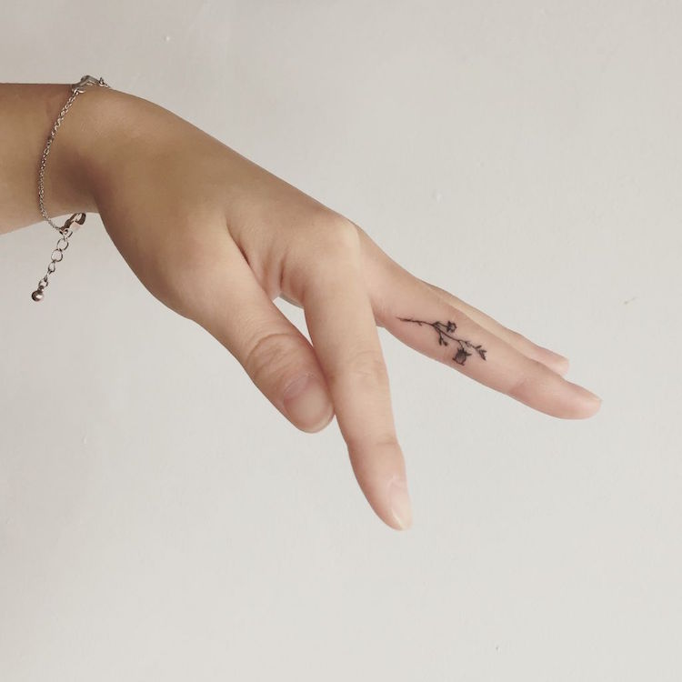 tatouage sur le doigt majeur fleur