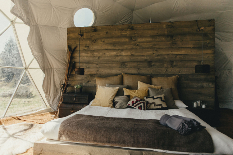 camping de luxe Kochi lit double coussins literie tete de lit bois