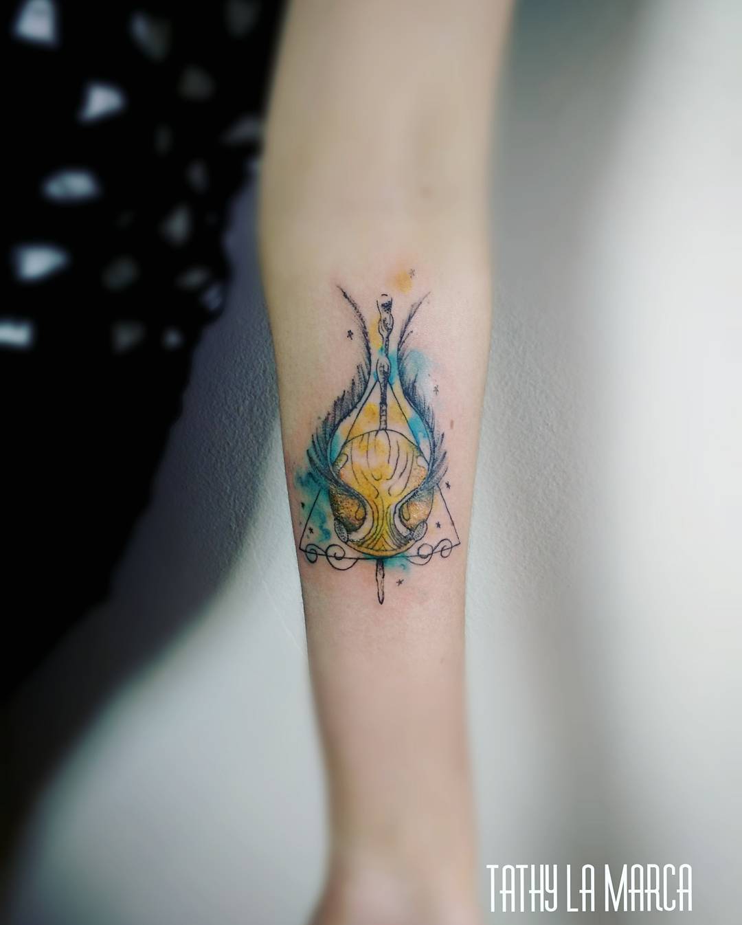 tatouage Harry Potter sur l'avant-bras vif d'or
