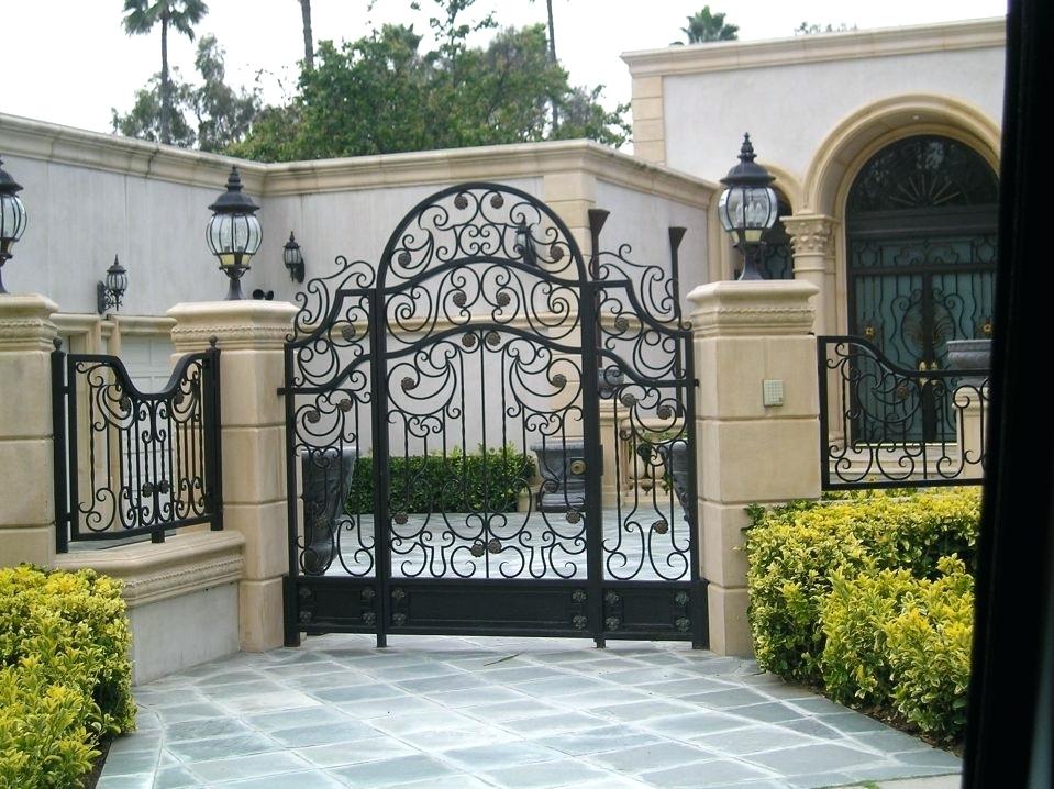 portail en fer forgé piliers en pierre jardin devant maison