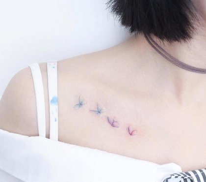 tatouage doux femme clavicule design coloré transparent