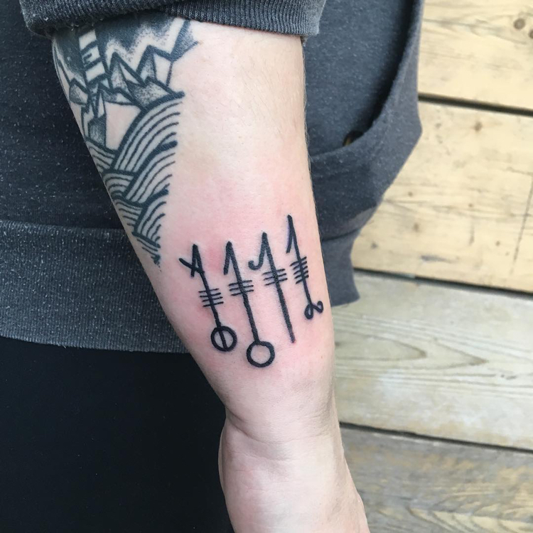 tatouage viking signification runes modèle bras homme