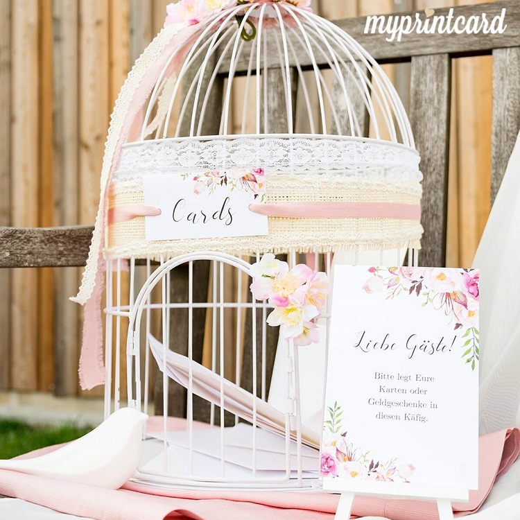cage d'oiseau vintage en couleur blanche avec un ruban rose