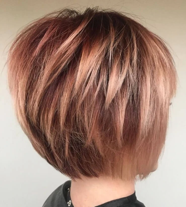 Short decadent strawberry blonde haircut for women over 50
