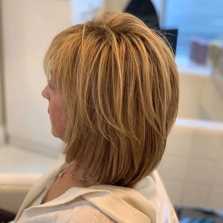 Dilapidated short haircut of a 50-year-old woman with silky smooth hair