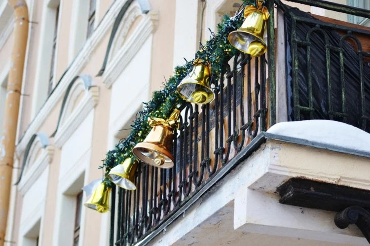 décoration balustrade balcon avec guirlande faux sapin et cloches de Noel dorées