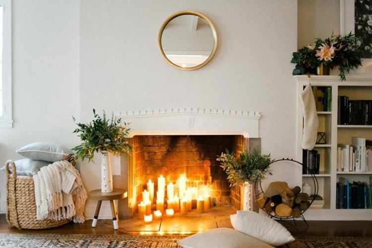 déco hygge pour Noel bougies allumées dans la cheminée coussins de sol plaid cozy