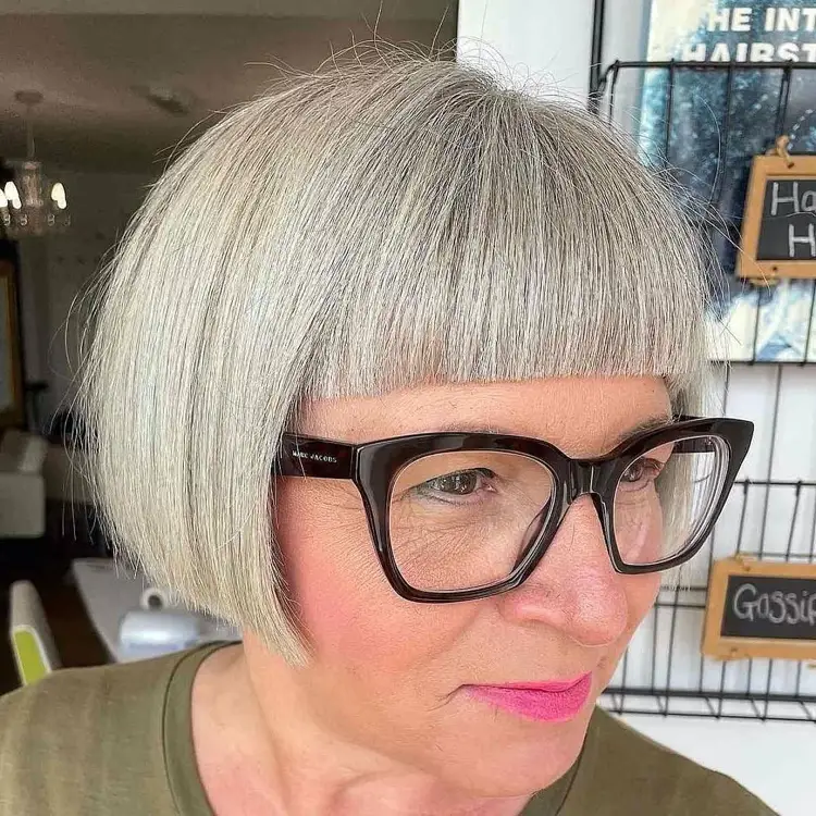 coiffure femme 60 ans avec des lunette et frange droite