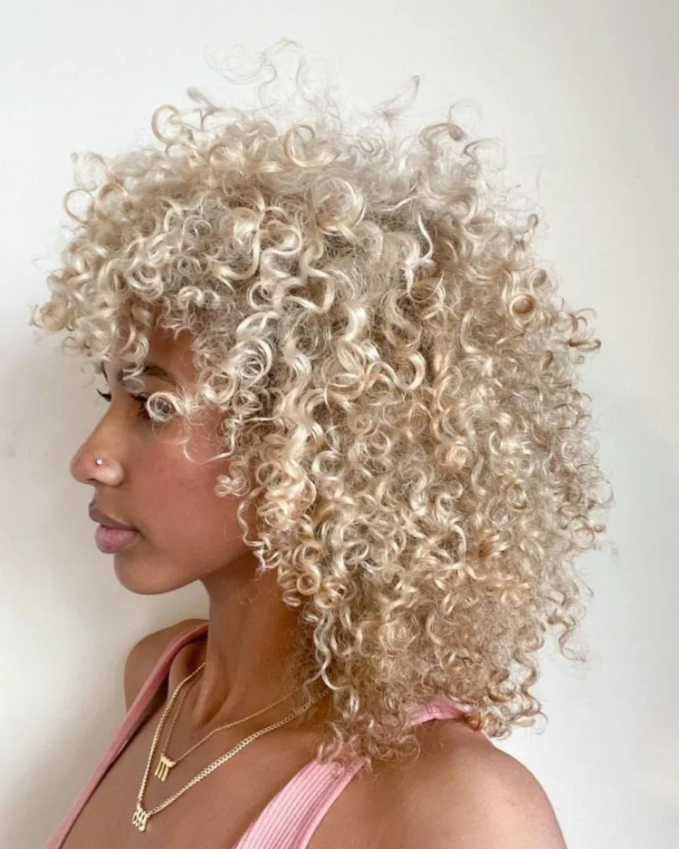 woman cut afro wolf cut hair wavy blond curls