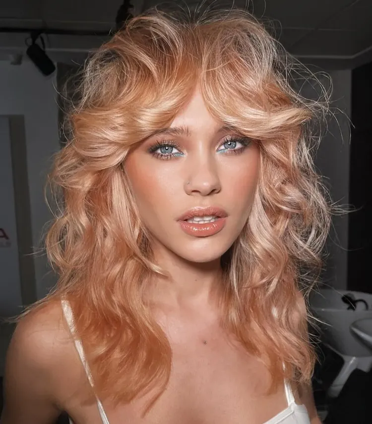 coloring idea wolf cut wavy hair strawberry blond hairstyle curly hair woman trend