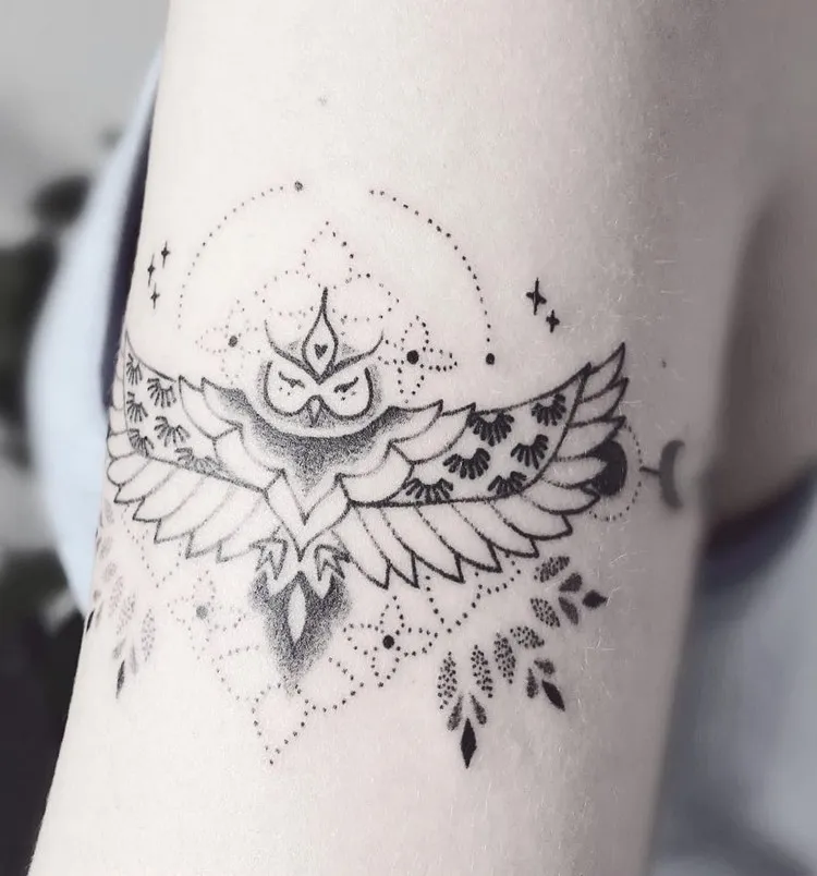 minimalist owl tattoo on the arm in a delicate mandala style tattoo for women