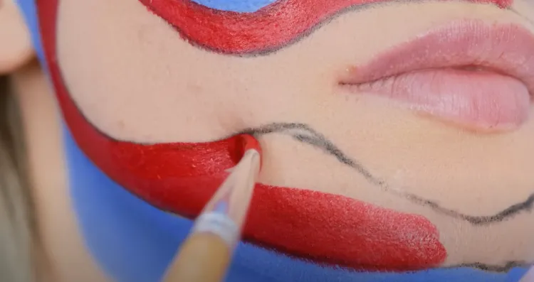 tuto maquillage huggy wuggy pour Halloween 2022 peinture bleue rouge étapes