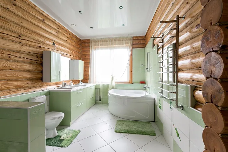 salle de bain avec un carrelage en verte pastel et des murs en bois