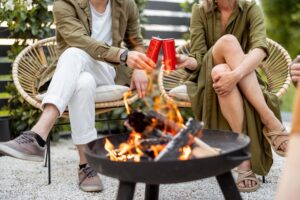friends by a fireplace outdoors