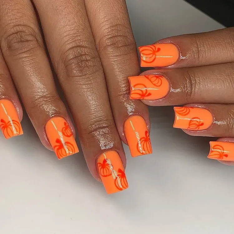 déco ongles automne 2023 citrouilles nail art orange vif