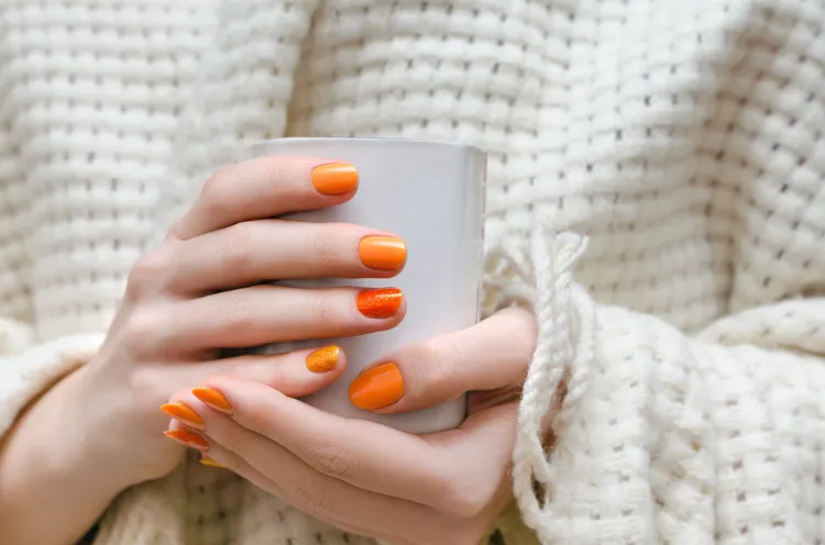 une idée de manucure courte avec un vernis orange mandarine douce