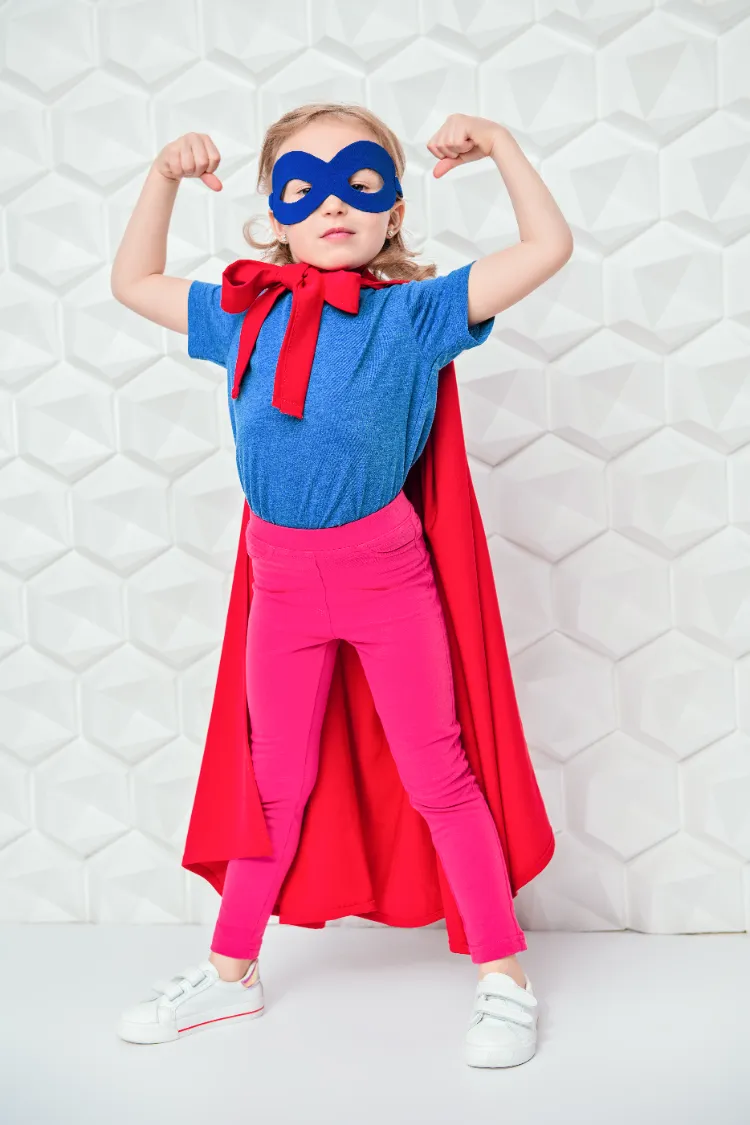 une petite fille super héroine dans un costume fait maison