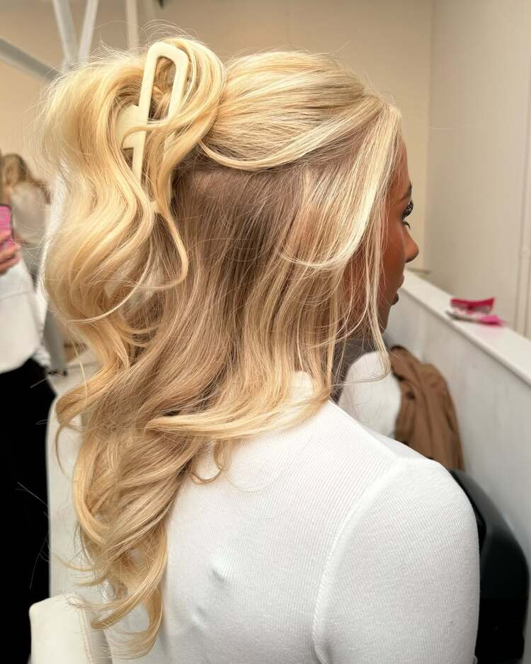 cheveux volumineux et lâchés, pleins de mouvement et fixés par une pince xxl