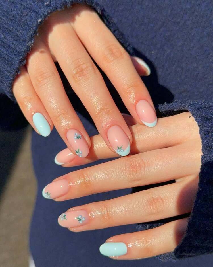 ongles pastel rose et bleu clair enjolivés de petites myrtilles un look doux aux airs printaniers