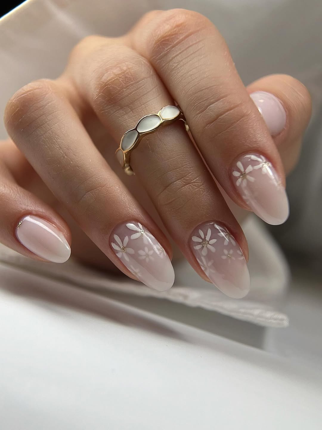 Déco ongles à effet laiteux qui se combine avec de petites fleurs délicates