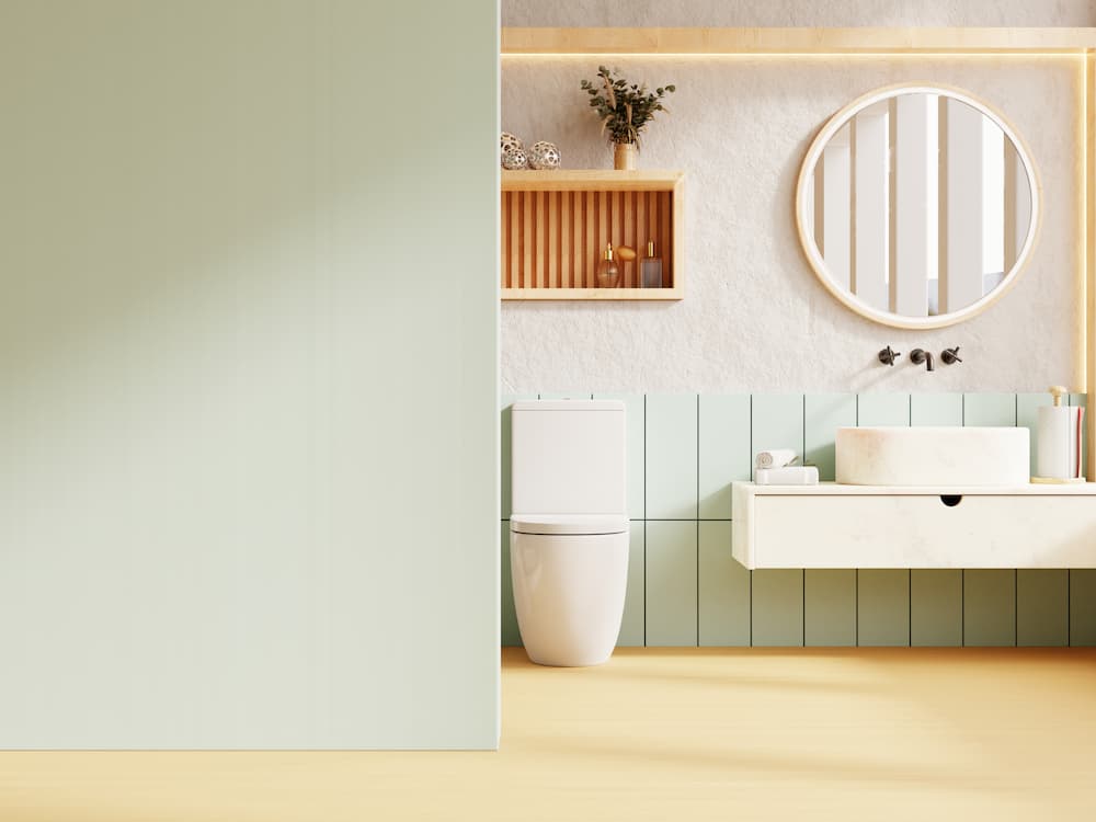salle de bain minimaliste peinture murale vert sauge pâle et blanc cassé bois clair atmosphère douce