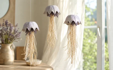 Trois méduses en boîte à œufs et lavande séchée suspendues devant une fenêtre baignée de lumière naturelle